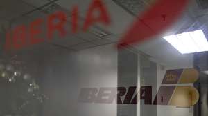 epa12545022 An Iberia airline logo outside one of its offices in the Cristal Park Tower in Caracas, Venezuela, 23 November 2025. The cancellation of flights to Venezuela by several airlines follows an advisory by the US Federal Aviation Administration (FAA) urging extreme caution when flying over the country and the southern Caribbean Sea amid a US military build-up in the region.  EPA/MIGUEL GUTIERREZ