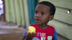 epa08372871 A South African boy from the 7de Laan shack settlement holds apples he received from the 9 Miles Project Covid-19 community support programme in Strandfontein, Cape Town, South Africa, 20 April 2020. The 9 Miles Project Covid-19 community support programme feeds over 1500 people from vulnerable coastal communities across Cape Town. Born out of a surf outreach initiative the 9 Miles Project is a registered non-profit organisation (NPO) founded in 2013 by Nigel Savel. The project works with youth in coastal informal settlements and provides mentorship and support to the at-risk youth. Now with extreme lockdown measures in place food security is a massive problem in South Africa.  The 9 Miles Project Covid-19 community support programme is one of the organisations that has stepped into this void to try alleviate the growing hunger across the city.  EPA/NIC BOTHMA ATTENTION: This Image is part of a PHOTO SET