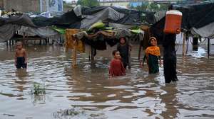epa13126323 Children play in floodwater following heavy monsoon rains in Peshawar, Pakistan, 22 July 2026. Heavy monsoon rains, fueled by active monsoon currents and a westerly wave, have triggered flash floods and widespread damage across Pakistan's northwestern Khyber Pakhtunkhwa province. Authorities said at least 18 people have died in rain-related incidents, while the Pakistan Meteorological Department (PMD) warned of urban flooding and landslides in Peshawar and surrounding areas. Rescue and relief operations are ongoing as the National Disaster Management Authority (NDMA) maintains a nationwide high alert amid continuing monsoon rains.  EPA/BILAWAL ARBAB