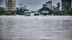 epa11300393 Vehicles are stuck in a flooded street in Jangwani, Dar Es Salaam, Tanzania, 25 April 2024. Tanzania Prime Minister Kassim Majaliwa said at least 155 people have died in Tanzania as torrential rains linked to El Nino weather phenomenon caused flooding and landslides, affecting about 200,000 people.  EPA/DIEGO MENJIBAR