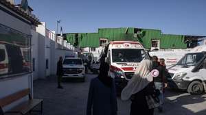 epa12888262 Ambulances wait at the Red Crescent headquarters before transporting injured Palestinians toward the Rafah land crossing for transfer abroad to receive medical treatment, in Khan Younis, southern Gaza Strip, 14 April 2026. The WHO said it resumed medical evacuations from Gaza on 12 April after the process was suspended on 6 April following a security incident in which a person contracted to provide services to WHO in Gaza was killed.  EPA/HAITHAM IMAD