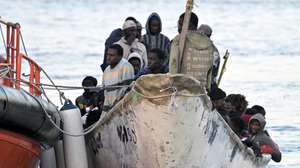 epaselect epa11793801 A small boat, carrying a group of rescued migrants, is towed by Spain's Maritime Rescue vessel Salvamar Adhara upon its arrival to the port of La Restinga, El Pinar municipality, El Hierro island, Canary Islands, Spain, 26 December 2024. The Canary Islands' migration route continues to expand with three small boats, carrying nearly 200 people, arriving on 26 December in Tenerife and El Hierro islands.  EPA/GELMERT FINOL