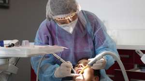 epaselect epa08416579 Dentist Alexandra Smooth, wears personal protect equipement, due to the coronavirus pandemic, as she works on a patient at her practice in Gignac, France, 12 May 2020. According to media reports, on 11 May 2020, France began to ease coronavirus restrictions, after 55 days of total lockdown.  EPA/GUILLAUME HORCAJUELO