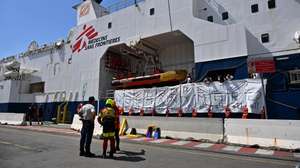 epa11403495 The crew of Doctors Without Borders (MSF) search and rescue vessel 'Geo Barents' display 11 white bags used to recover the bodies of dead migrants and life jackets with the words reading 'Europe...How many more?', to symbolize the bodies recovered at sea, upon arrival at the port of Genoa, Italy, 11 June 2024. Geo Barents ship docked at the port carrying 165 migrants, mainly from Eritrea, rescued in the Libyan area. Among the rescued migrants are 109 recovered onboard a rubber dinghy and 37 from a fiberglass boat. There are 33 minors on board, around thirty of whom are unaccompanied. While traveling towards Genoa, the ship recovered 11 bodies at sea for migrants who drowned in a previous shipwreck, before they were transferred to a Coast Guard patrol boat near Lampedusa.  EPA/LUCA ZENNARO
