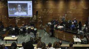 epa11692761 Fernanda Gonzalez Chaves (screen) gives her testimony during the trial for the murder of Marielle Franco, in Rio de Janeiro, Brazil, 30 October 2024. The trial against former members of the Military Police of Rio Ronnie Lessa and Elcio Queiroz, accused of the murder of Brazilian councilwoman and human rights activist Marielle Franco, began on 30 October. Franco was shot dead on 14 March 2018 along with Anderson Gomes, the driver of the vehicle in which she was traveling, after participating in a political event in downtown Rio de Janeiro. The prosecution requested the maximum sentence of 84 years in prison for the accused.  EPA/ANTONIO LACERDA