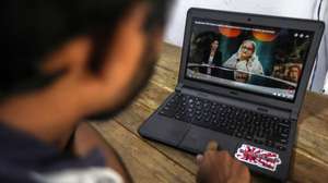 epa11529908 A Sri Lankan man watches the news about the resignation of Bangladesh's prime minister, in Colombo, Sri Lanka, 06 August 2024. In an address to the nation, Chief of Army Staff General Waker-Uz-Zaman announced on 05 August that Bangladeshi Prime Minister Sheikh Hasina resigned after weeks of unrest and an interim government will be formed to run the country. Violence broke out in Dhaka and other regions following student-led protests demanding reforms to the government's job quota system.  EPA/CHAMILA KARUNARATHNE