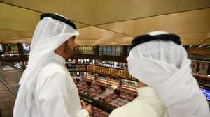 epa08280415 People observe the development of the Boursa Kuwait national stock market, in Kuwait City, Kuwait, 09 March 2020. According to media reports, Kuwait stock exchange on 09 March stopped trading after main index dropped by 10 percent as OPEC failure to reach an agreement on production brought oil prices down by more than 30 percent. Fears over Coronavirus effects on the economy and the oil crisis also affected stock markets in Gulf countries, with Saudi and UAE share went down and Saudi oil giant Aramco shares have lost 10 percent of their value.  EPA/NOUFAL IBRAHIM