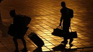 epa08420049 Venezuelan migrants walk with their suitcases towards the buses that will take them to the Venezuelan border, in a voluntary return to their country from Cali, Colombia, 13 May 2020. The mayoralty of Cali and Migracion Colombia facilitated land transportation for the 500 Venezuelans who decided to return to their country in the midst of the COVID-19 pandemic, which has reduced their chances of surviving in foreign lands.  EPA/ERNESTO GUZMAN JR