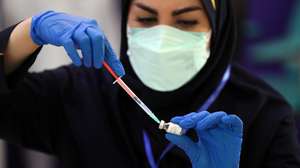 epa09157858 An Iranian health worker prepares to administer a shot of the locally-made 'COVIRAN Barekat' at the beginning of the third phases of the human test of the vaccine, in Tehran, Iran, 25 April 2021. Phases three of clinical trials of the locally-made COVID-19 vaccine began on 25 March, after the second phase of human trials took place on 15 March. According to Mohammad Mokhber, the head of COVIRAN Barekat vaccine department, the vaccine will be ready in summer 2021 for massive vaccination in Iran.  EPA/ABEDIN TAHERKENAREH