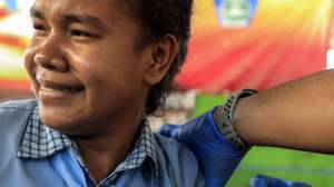 epa09584856 A student reacts as a healthcare worker injects a Pfizer COVID-19 vaccine dose during a vaccination drive for children over twelve years of age in Dili, East Timor, also known as Timor Leste, 16 November 2021. East Timor has recorded more than 19,000 coronavirus (COVID-19 disease) cases since the beginning of the pandemic.  EPA-EFE/ANTONIO DASIPARU