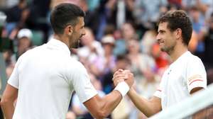 epa11452859 Novak Djokovic (L) of Serbia is congratulated at the net by Vit Kopriva of the Czech Republic after winning their Men's 1st round match at the Wimbledon Championships, Wimbledon, Britain, 02 July 2024. Djokovic won in three sets.  EPA/NEIL HALL  EDITORIAL USE ONLY