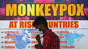 epa10334196 (FILE) - An Indian health worker walks in front of a list of high-risk countries for the Monkeypox virus, at Chennai International Airport, in Chennai, India, 16 July 2022 (reissued 28 November 2022). The World Health Organization (WHO) in a statement on 28 November 2022 said it "will begin using a new preferred term mpox as a synonym for monkeypox" simultaneously for one year until the term 'monkeypox' is phased out. The decsion was taken after consultations with global experts as "racist and stigmatizing language online, in other settings and in some communities was observed and reported to WHO."  EPA/IDREES MOHAMMED