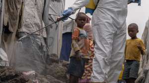 epa11559878 A Red Cross worker sprays chlorine as other Red Cross personnel raised awareness about mpox and hygiene among internally displaced people in the Don Bosco camps in Goma, Democratic Republic of Congo, 22 August 2024. The World Health Organization has declared the ongoing outbreaks of monkeypox (MPOX) in Congo and elsewhere in Africa a global emergency. Mpox causes fever, rash, and lesions all over the body, severe headaches, and fatigue.  EPA/MOISE KASEREKA