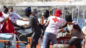 epa11569305 Maritime Rescue assist rescued migrants to be transferred to the port of Arguineguin, in Canary Islands, Spain, 28 August 2024. The 120 people of sub-Saharan origin were rescued the previous day from a cayuco that was located 520 kilometres from the Canary Islands. The boat was occupied by 94 men, 15 women and 11 minors in apparent good health. EFE/Quique Curbelo  EPA/QUIQUE CURBELO