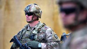 epa08330258 US soldiers stand guard during the handover ceremony of the K1 Air Base near Kirkuk city, northern Iraq, 29 March 2020. The US-led coalition forces withdrew from the third military bases in northern Iraq, amid heightened tensions with Iran-backed Iraqi Shiite armed groups in Iraq.  EPA/MURTAJA LATEEF