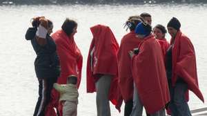 epa11709942 Sub-Saharan immigrants await assistance upon arriving at Arrecife port, Spain, 08 November 2024. The Navy and Red Cross rescue crews were successful in saving a number of the 110 Sub-Saharan migrants who were stranded at sea in two small boats.  EPA/ADRIEL PERDOMO