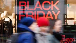 epa11747770 Passers by walk in front of a shopping window that reads 'Black Friday' in Berlin, Germany, 29 November 2024. Black Friday 2024 takes place on 29 November 2024.  EPA/CLEMENS BILAN