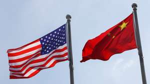 epa12293338 National flags of the United States and China are seen in front of the General Electric Science Park in Beijing, China, 11 August 2025. 12 August marks the deadline for the 90-day extension of the truce about the reciprocal tariffs between the US and China.  EPA/WU HAO