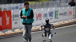 epaselect epa12040346 A N2 robot approaches to the finish line during a half marathon run by humans and humanoid robots in Beijing, China, 19 April 2025. China hosts the world’s first all-robot marathon in Beijing, showcasing the speed, agility, and performance of humanoid robots.  EPA/ANDRES MARTINEZ CASARES