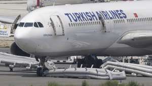 epa12946801 Ground staff collect an emergency ladder from a Turkish Airlines aircraft after a landing gear fire at Tribhuvan International Airport in Kathmandu, Nepal, 11 May 2026. A Turkish Airlines Airbus A330 operating a flight from Istanbul to Kathmandu suffered a tyre fire during landing at Tribhuvan International Airport, triggering an emergency evacuation and temporarily shutting down Kathmandu's international airport.  EPA/NARENDRA SHRESTHA