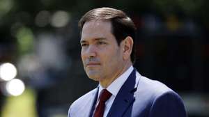 epa12951304 US Secretary of State Marco Rubio watches as US President Donald Trump talks to the media before leaving the South Lawn of the White House, Washington, DC, USA, 12 May 2026. President Trump is leaving the US to visit China where he will meet with President Xi in Beijing.  EPA/WILL OLIVER