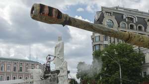 epa13063725 A worker cleans the monument to Princess Olga next to an exhibition of destroyed Russian military machinery on Mykhailivska Square in Kyiv, Ukraine, 25 June 2026, amid the ongoing Russian invasion. Specialists of the Ukrainian multi-service company 'INVITE' are opening and cleaning significant monuments in Kyiv after their protective conservation, which was carried out at the start of the Russian invasion in 2022.  EPA/SERGEY DOLZHENKO