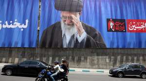 epaselect epa13077300 Iranians ride a motorbike past a large-scale poster of late Iranian Supreme Leader Ayatollah Ali Khamenei displayed along a highway, in Tehran, Iran, 01 July 2026. Iran is set to hold a multi-day state funeral from 04 to 09 July 2026 for late Iranian Supreme Leader Ayatollah Ali Khamenei, who was assassinated on 28 February.  EPA/ABEDIN TAHERKENAREH  -- RESTRICTIONS: NO Access Israel Media/Persian Language TV Stations Outside Iran/Strictly No Access BBC Persian/VOA Persian/Manoto TV/Iran International TV. (As mandated by Iran's Directorate General for Foreign Media) --