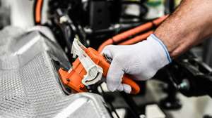 epa12368867 (FILE) - A Volkswagen employee plugs in a battery as  he works on the carriage unit of an e-Golf on the production line of the so-called 'Glaeserne Manufaktur' ('Transparent Factory') in Dresden, Germany, 25 April 2017 (reissued 11 September 2025). The automobile sector is a vital part of the European economy, according to Eurofound and Eurostat, it provides around 6.72 million direct jobs. The entire industry accounts for 7% of Europe’s GDP. The sector is currently undergoing a major transformation propelled by electromobility, integration of new technologies, and increasing competition from countries like China. In January 2025, the European Commission launched the Strategic Dialogue on the Future of the Automotive Industry to foster innovation and maintain the industry’s competitiveness.  EPA/FILIP SINGER *** Local Caption *** 53478609