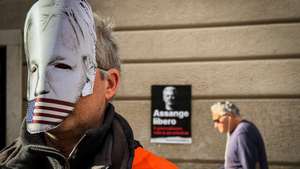 epa10380133 Activists participate in the solidarity demonstration in favor of Julian Assange, outside of the headquarters of the city council of Naples, in Naples, Italy, 28 December 2022. Activists presented a layout of the cell space in which Julian Assange is being held prisoner during their protest. The WikiLeaks founder Julian Assange is in his fourth year of imprisonment in the UK whilst the US government tries to extradite him to face charges of espionage.  EPA/CESARE ABBATE