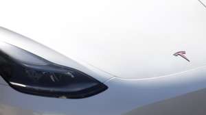 epa11861429 A logo is displayed on a Tesla car that is parked outside of a Tesla showroom in Burbank, California, USA, 29 January 2025. Tesla is set to report its fourth-quarter earnings after the close of the US stock market.  EPA/CAROLINE BREHMAN