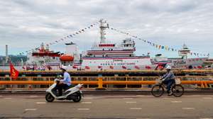 epa12361415 Taiwanese workers drive past the Taiwan Coast Guard's Hualien CG1006 frigate during the delivery ceremony for the new frigate, at Keelung port in Keelung, Taiwan, 08 September 2025. The 1,000-ton Hualien CG1006 patrol vessel is part of Taiwan Coast Guard fleet development program to further safeguard national sovereignty and maritime security.  EPA/RITCHIE B. TONGO