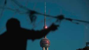 epa10987215 A worker hangs Christmas decorations against Shanghai Oriental Pearl Tower in Shanghai, China, 21 November 2023. According to local customs, Shanghai's imports and exports during the first 10 months of this year reached a total of 3.51 trillion yuan, which is roughly equivalent to 490.1 billion U.S. dollars. This reflects a year-on-year increase of 1.9 percent. During this period, Shanghai's exports increased by 2.3 percent to 1.44 trillion yuan, while imports rose by 1.6 percent to 2.07 trillion yuan. Data from Shanghai Customs showed that Shanghai's trade with the European Union amounted to 711.15 billion yuan, accounting for 20.2 percent of its total foreign trade volume during the period. In the same period, Shanghai exported 1 trillion yuan worth of mechanical and electrical products, which is 69.3 percent of the city's total export value. At the same time, the city imported 473.59 billion yuan worth of consumer goods, accounting for 22.9 percent of the total import value.  EPA/ALEX PLAVEVSKI