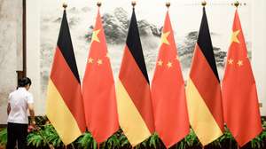 epa07821803 A cleaning aid sweeps with a broom next to a row of flagpoles displaying the German and Chinese flags prior to a welcome ceremony with military honors for German Chancellor Angela Merkel, held by Chinese Premier Li Keqiang (both not pictured) at the Great Hall of the People in Beijing, China, 06 September 2019. German Chancellor Angela Merkel in on a visit to China from 06 to 07 September 2019.  EPA/CLEMENS BILAN