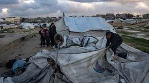 epa12639019 A Palestinian family is trying to gather what remains of their belongings after their tent was damaged in Khan Younis in the southern Gaza Strip, 09 January 2026. The tent sheltering the Palestinian family was destroyed by strong winds and heavy rain, leaving the family without shelter.  EPA/HAITHAM IMAD