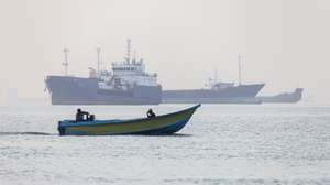 epa13009258 A handout photo made available by Isna News Agency shows Iranian fishermen steering a boat past ships stuck in the Strait of Hormuz, along the coast of Bandar Abbas, in southern Iran, 01 June 2026. According to Iranian state media, the military's central command warned all vessels to secure Islamic Revolution Guards Corps (IRGC) Navy clearance to pass through the strait or face maritime security risks.  EPA/AMIRHOSSEIN KHORGOOEI/ ISNA NEWS AGENCY HANDOUT RESTRICTIONS: NO Access Israel Media/Persian Language TV Stations Outside Iran/Strictly No Access BBC Persian/VOA Persian/Manoto TV/Iran International TV. (As mandated by Iran's Directorate General for Foreign Media) -- HANDOUT EDITORIAL USE ONLY/NO SALES
