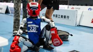 epa13186696 Team members set a humanoid robot for the Lightweight event at the 2026 World Humanoid Robot Games at the National Speed Skating Oval in Beijing, China, 23 August 2026. The 2026 World Humanoid Robot Games are being held in Beijing until 26 August.  EPA/WU HAO