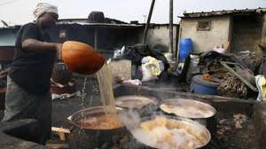 epa10428585 A woman prepares Dolo (African traditional beers brewed with sorghum malt) at a cabaret in Koumassi, a popular district of Abidjan, Ivory Coast, 25 January 2023. The Dolo is an indigenous traditional beer made in West Africa (Cote D'Ivoire, Burkina Faso), from cereals. The Dolo is produced in northern Cote D'Ivoire and southern Burkina Faso. In Cote D'Ivoire it is consumed by the Senoufo, the Lobi and the Koulango Ethnie living in the North. In Cote D'Ivoire, a variant of the Dolo is made with corn and is drunk sugary. It is preserved in canaries, and is drunk in calabashes. The dolo is drunk in 'cabarets' found in markets. It is served in calabashes by the one who makes it, called 'dolotiere', this trade being exclusively feminine. The dolo must be drunk during the day because the fermentation continues. The next day, in general, it becomes too strong. Modernized agro-food production trials in Abidjan have been successful, but consumption remains very minor. The Dolo's price is 0.61 euros (400 FCFA) in Ivory Coast.  EPA/LEGNAN KOULA