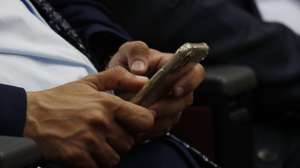 epa10633435 A Yemeni makes SMS with a smartphone on the World Telecommunication and Information Society Day, in Sana'a, Yemen, 17 May 2023. The World Telecommunication and Information Society Day (WTISD) is an annual observance that is celebrated on 17 May to raise awareness about the importance of telecommunications and the role of information and communication technologies (ICTs) in promoting social and economic development worldwide.  EPA/YAHYA ARHAB