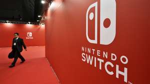 epa09180302 (FILE) - A man walks past the Nintendo Switch logo during the Nintendo Switch Presentation 2017 in Tokyo, Japan, 13 January 2017 (reissued 06 May 2021). On 06 May 2021, Nintendo Co. announced that its consolidated financial results for the fiscal year ended March 2021 reached a record high with net income of 4.4 billion USD, up 85.7 percent from the previous year thanks to strong sales of its Switch game console.  EPA/FRANCK ROBICHON