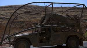 epa13108719 An Israeli military vehicle covered with netting to protect against FPV drones patrols along the Israel-Lebanon border, 13 July 2026.  EPA/ATEF SAFADI
