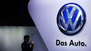 epa12399708 (FILE) - A file photo dated 20 April 2015 showing a man taking photos beside the Volkswagen logo at the 16th Shanghai International Automobile Industry Exhibition in Shanghai, China (reissued 23 September 2025). September 2025 marks a decade since the Volkswagen emissions scandal exposed widespread cheating on vehicle emissions tests in German car makers. The scandal, commonly known as Dieselgate, resulted in high-profile executive resignations, criminal convictions, and had profound, lasting effects on the automotive industry, environmental health, and public policy, with many consequences still unfolding today such as reputational fallout for the German automotive industry and major changes in emissions regulations in Europe.  EPA/HOW HWEE YOUNG *** Local Caption *** 52235128
