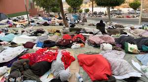 epa13233473 Migrants sleep on the street near the Loma Colmenar holding area in Ceuta, Spain, 12 September 2026, waiting to be transferred to a temporary migrant center or relocated.  EPA/REDUAN
