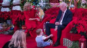 epa11787566 US First lady Dr. Jill Biden reads from 'Twas the Night Before Christmas' while United States President Joe Biden plays with John 'Reuben' Unkovic during a holiday visit to patients and families at Children's National Hospital in Washington, DC, USA, 20 December 2024.  EPA/CHRIS KLEPONIS / POOL