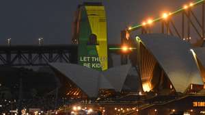 epa12582280 The social media ban for children under 16 with the slogan 'Let Them Be Kids' is seen projected on the pylons of the Sydney Harbour Bridge in Sydney, Australia, 10 December 2025. Australia's ban on social media for users aged under 16 came into effect on 10 December.  EPA/MICK TSIKAS  AUSTRALIA AND NEW ZEALAND OUT