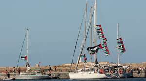 epa12373743 Palestinian fags fly aboard boats of the Global Sumud Flotilla (GSF) before their departure from the port of Bizerte, northern Tunisia, 13 September 2025. The GSF flotilla is an international maritime initiative that began sailing in August 2025 en route to Gaza, aiming to break the Israeli blockade and deliver vital aid to the Gaza Strip.  EPA/MOHAMED MESSARA