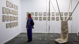 epa10484132 A woman looks at several artworks belonging to Proyecto Ultravioleta collection at ARCO Madrid International Contemporary Art Fair at IFEMA Madrid fair ground, in Madrid, Spain, 22 February 2023. ARCOmadrid fair celebrates its 42nd edition from 22 to 26 February 2023 with the participation of 218 galleries and The Mediterranean Sea as the central theme.  EPA/Rodrigo Jimenez