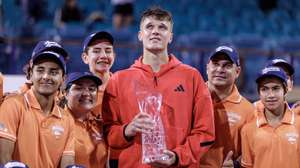 epa12000536 Jakub Mensik of Czechia (C) holds the trophy, surrounded by the ball persons, after winning the Men’s Singles Final match at the 2025 Miami Open tennis tournament at the Hard Rock Stadium in Miami, Florida, USA, 30 March 2025.  EPA/CRISTOBAL HERRERA-ULASHKEVICH