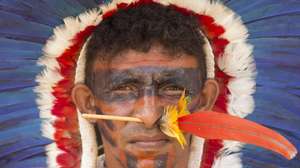 epaselect epa05927817 A Brazilian indigenous person stand in a protest next to Explanada dos Ministerios in Brasilia, Brazil, on 25 April 2017. Close to 2,000 indigenous people of several tribes of the country gathered in Brasilia to demand for the demarcation of their lands, which they claim as their own, in a protest that included brief confrontations with the Police in front of the Congress of Brazil.  EPA/Joédson Alves