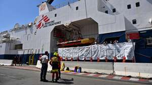 epaselect epa11403495 The crew of Doctors Without Borders (MSF) search and rescue vessel 'Geo Barents' display 11 white bags used to recover the bodies of dead migrants and life jackets with the words reading 'Europe...How many more?', to symbolize the bodies recovered at sea, upon arrival at the port of Genoa, Italy, 11 June 2024. Geo Barents ship docked at the port carrying 165 migrants, mainly from Eritrea, rescued in the Libyan area. Among the rescued migrants are 109 recovered onboard a rubber dinghy and 37 from a fiberglass boat. There are 33 minors on board, around thirty of whom are unaccompanied. While traveling towards Genoa, the ship recovered 11 bodies at sea for migrants who drowned in a previous shipwreck, before they were transferred to a Coast Guard patrol boat near Lampedusa.  EPA/LUCA ZENNARO