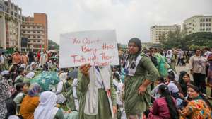 epa12253015 Bangladeshi students shout slogans and hold placards near the crash site after an air force training aircraft crashed into Milestone College campus in Dhaka, Bangladesh, 22 July 2025. According to the Inter-Services Public Relations (ISPR), the death toll from the 21 July aircraft crash at Milestone School and College in Dhaka’s Uttara has risen to 31. Additionally, 165 others were injured in the incident.  EPA/MONIRUL ALAM